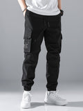 Manfinity Hypemode Loose Fit Men's Slogan Graphic Cargo Pants With Grommet Detail, Flap Pockets, And Drawstring Closure - MapleCo