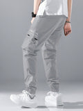 Manfinity Hypemode Loose Fit Men's Slogan Graphic Cargo Pants With Grommet Detail, Flap Pockets, And Drawstring Closure - MapleCo