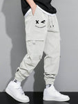 Manfinity Hypemode Loose Fit Men's Cargo Pants With Letter Graphic, Flap Pockets And Drawstring Waist