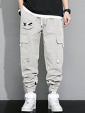 Manfinity Hypemode Loose Fit Men's Cargo Pants With Letter Graphic, Flap Pockets And Drawstring Waist