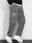 Manfinity Hypemode Men's Casual Cargo Pants With Slogan Graphic, Flap Pocket And Drawstring Waist - MapleCo