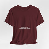 Surviving on caffeine and chaos. - Premium Tee